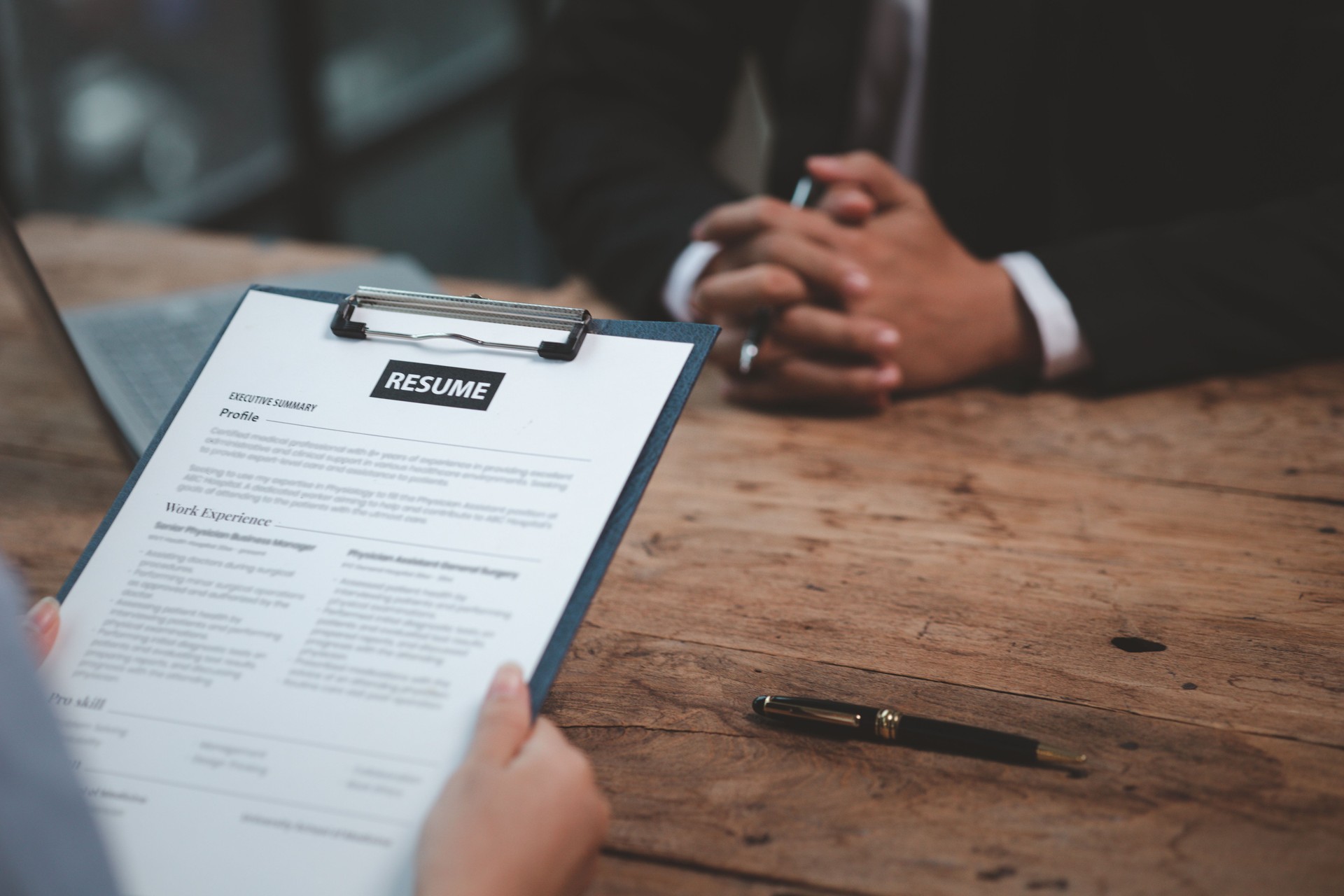Person submitting resume to interview for a job with a company, Person attending a job interview with a manager to be recruited to the company for the position applied for. Job application concept.